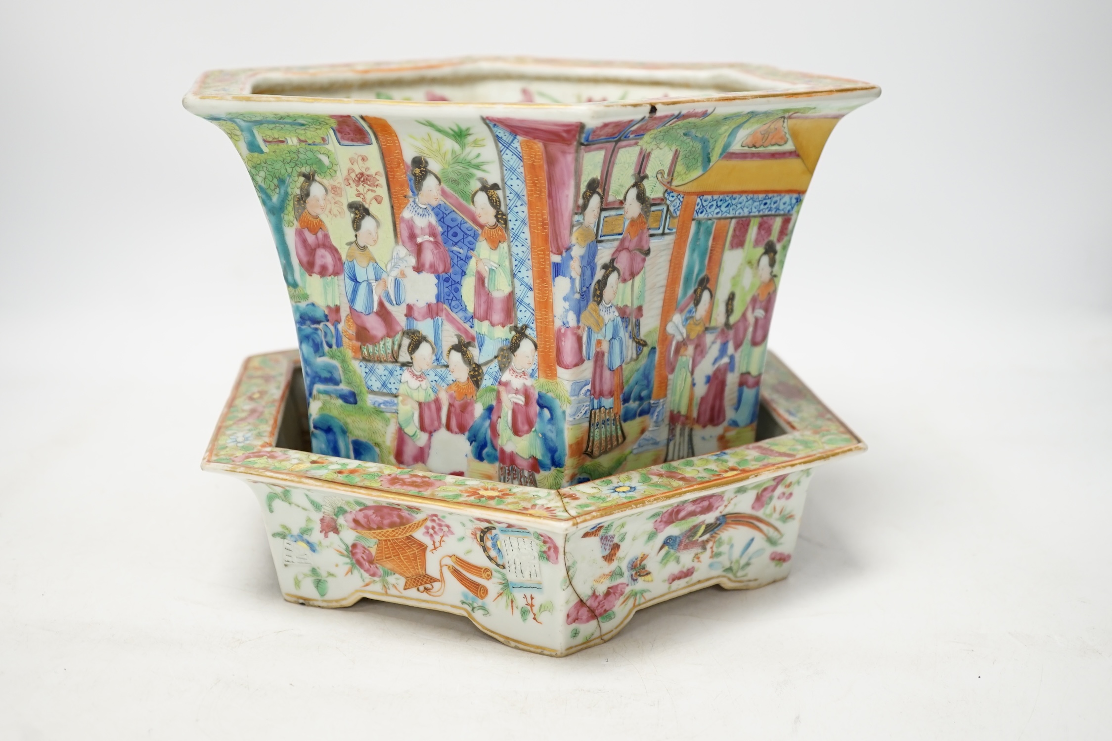 A 19th Chinese Canton decorated famille rose hexagonal planter, with stand, the stand cracked, 19.5cm total. Condition - fair